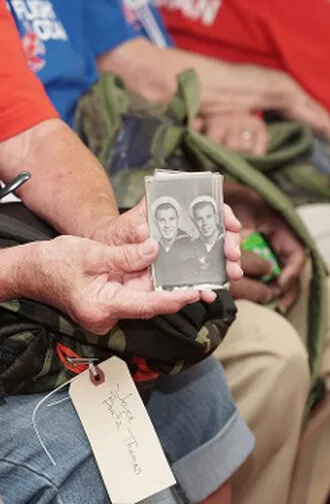 Someone showing old photos of Veterans when they were younger