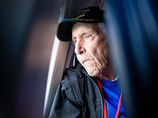 Portrait of an Honor Flight veteran wearing his flight cap