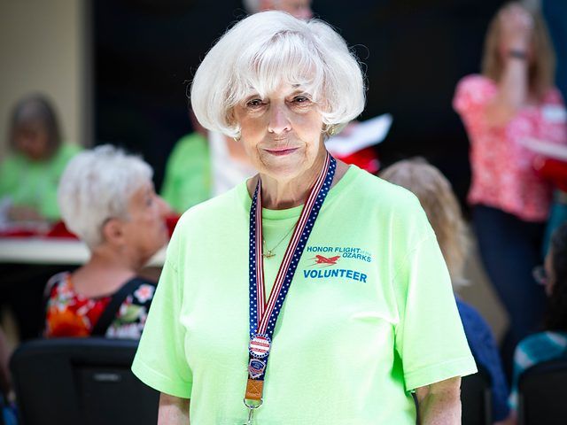 Honor Flight volunteer wearing a volunteer shirt and lanyard