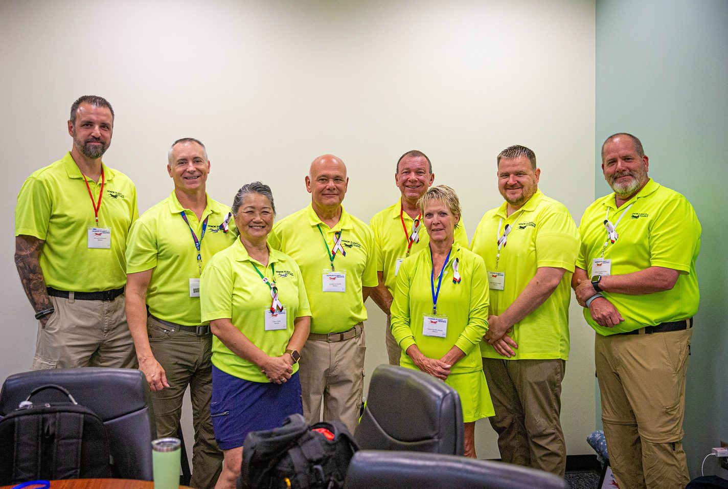 Honor Flight volunteers in yellow shirts before a flight